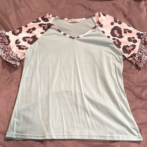 Miss look brand teal shirt with white/gray/ black leopard sleeves.